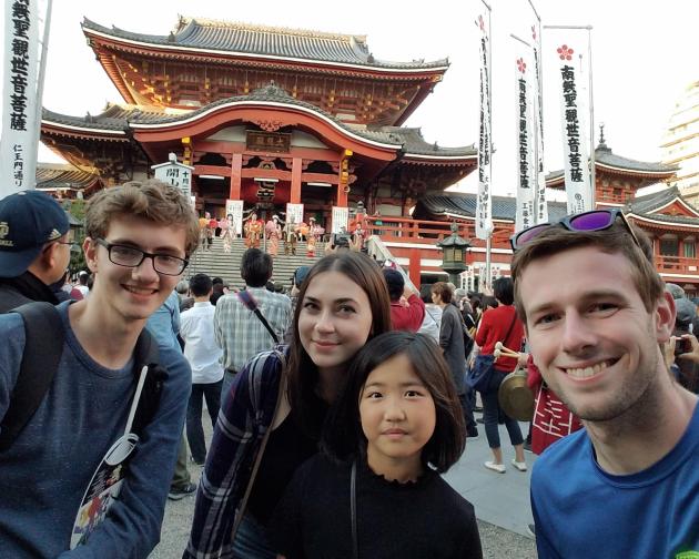 a group of students pose for a photo at the Osu Kannon Buddhist temple in Nagoya