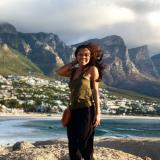 a student poses for a photo on the windy coast of Cape Town