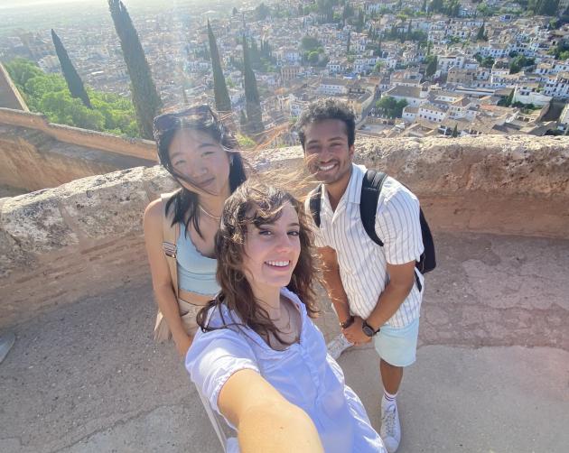 Three students taking a selfie on an overlook in Granada