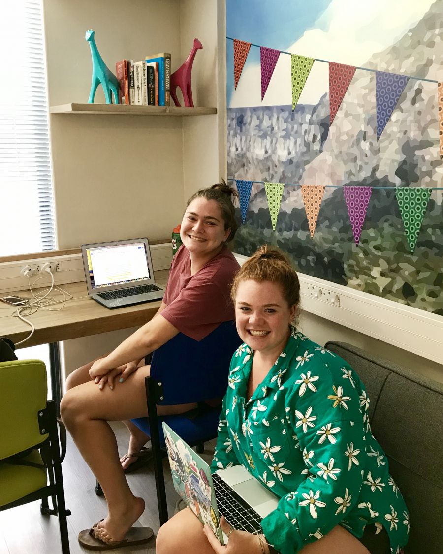 Two girls students at the student lounge smiling 