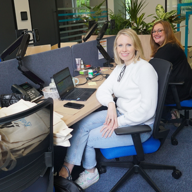 Two people sit at a desk in the IES Abroad London Center.