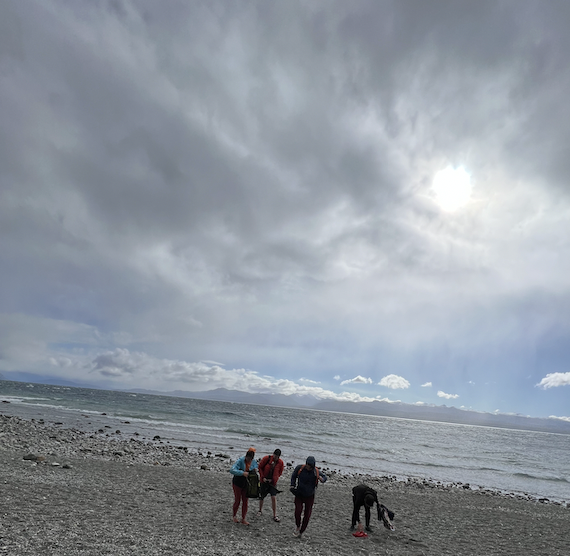 people walking back from the rocky beach