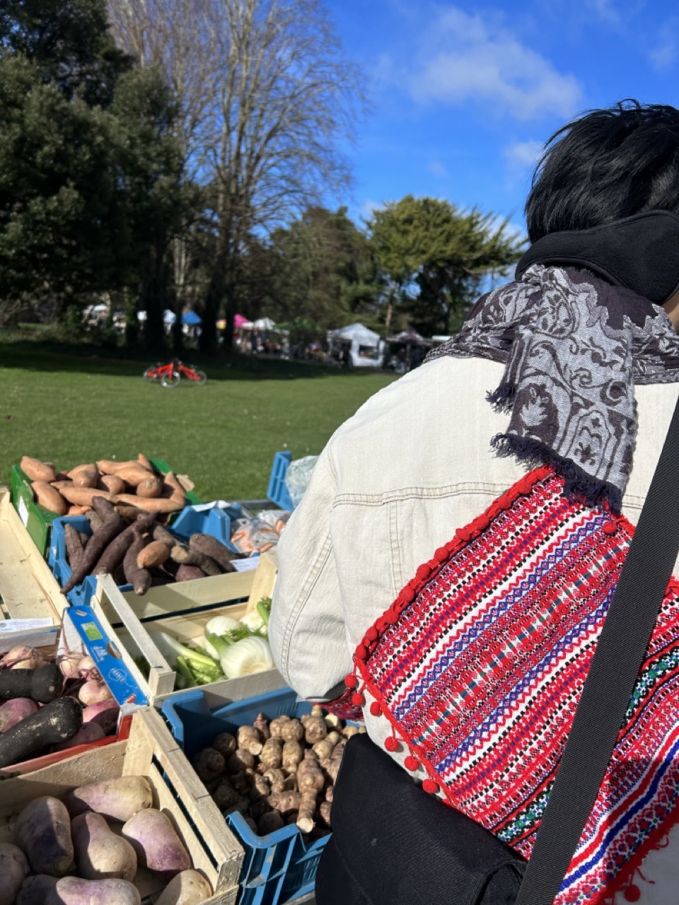 My friend next to a farmer's market stand 