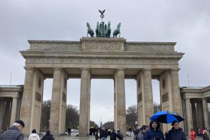 The Brandenburg Gate from the front, with six columns and five passageways. On top is a bronze a quadriga driven by a goddess figure, the green patina showing its age.