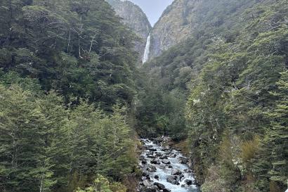 Waterfall in arthurs pass with stream and trees