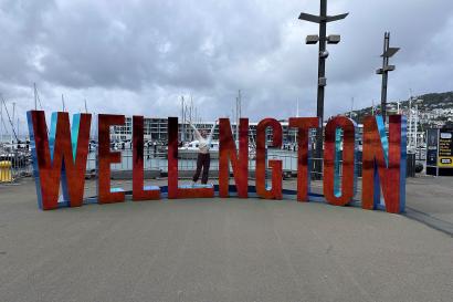 Person standing as the I in a giant red wellington sign