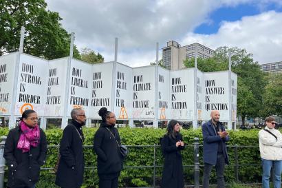 DWA Group in Berlin in a park standing in front of signs about Global Warming