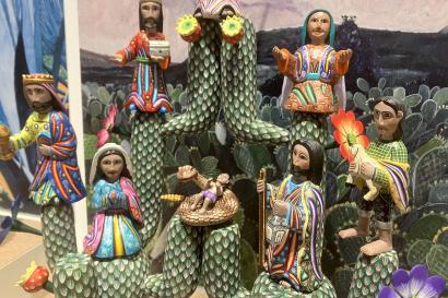 Image of cactus theme nativity scene, multiple figurines perched in branches