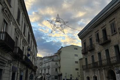 A star shaped light display hanging across the street of Isernia.