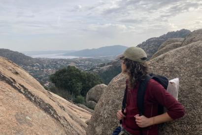 Photo of person overlooking the rocky and forest landscape of Manzanares el Real