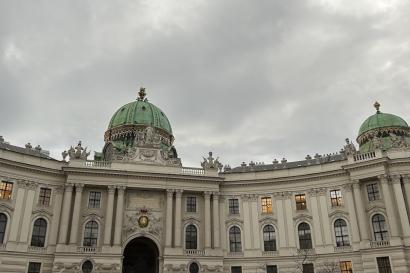 the camera points up at the Sisi Museum in Vienna's first district on a cloudy grey morning