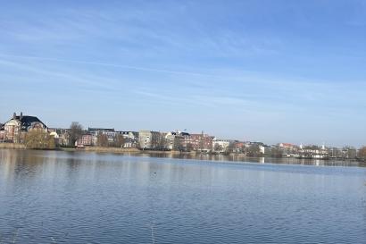 Picture of Copenhagen in the distance with water dividing the camera and the city on a sunny early March afternoon.