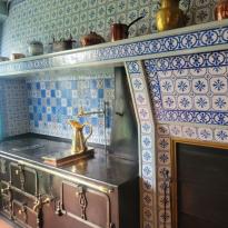 Claude Monet's kitchen with a blue and gold color scheme.