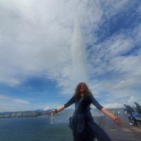 A ginger lady who is being drenched by a nearby jet of water
