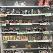 Shelves of onigiri, sandwiches and bento in a Seven Eleven. 