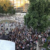 Crowd gathered in front of theater, photo taken from inside theater upstairs 