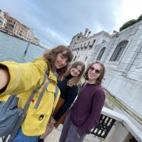 Selfie of three students in front of a canal in Venice. 