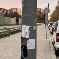 metal pole with two white stickers 