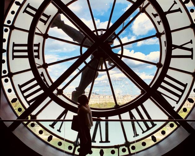 a student's silhouette behind a clock tower at Musee D'orsay