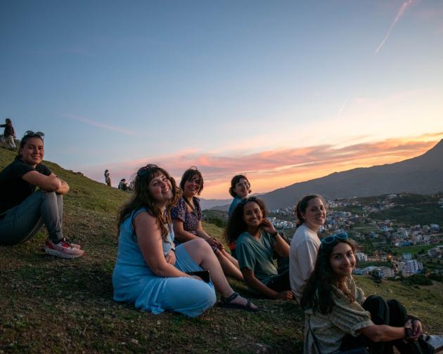 Students on hill at sunset overlooking Chefchaouen in Morocco.