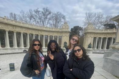 Group of 4 students in Retiro Park in Madrid wearing all black and sunglasse