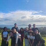 A panoramic picture of several members of IES Auckland on Waiheke Island.