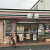 The storefront of a Seven Eleven store on a cloudy day in Tokyo. 