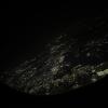 A picture taken through the plane window at night, hovering above the light-speckled outline of Florida in the direction of Germany.