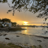 sunset beyond the beach, with a reflection on the water