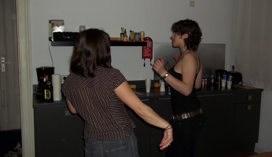 Two girls dance in a kitchen