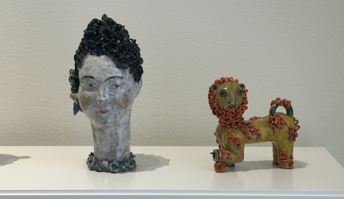 These are small abstract sculptures of a woman's head and a lion