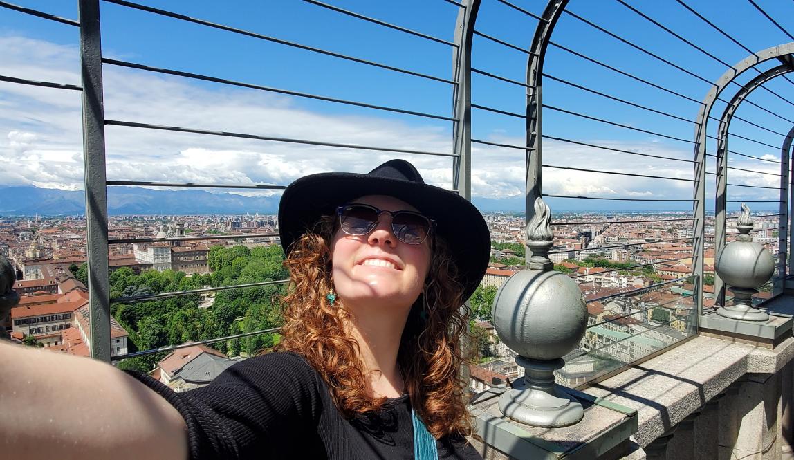 Ginger lady in a hat on a tower