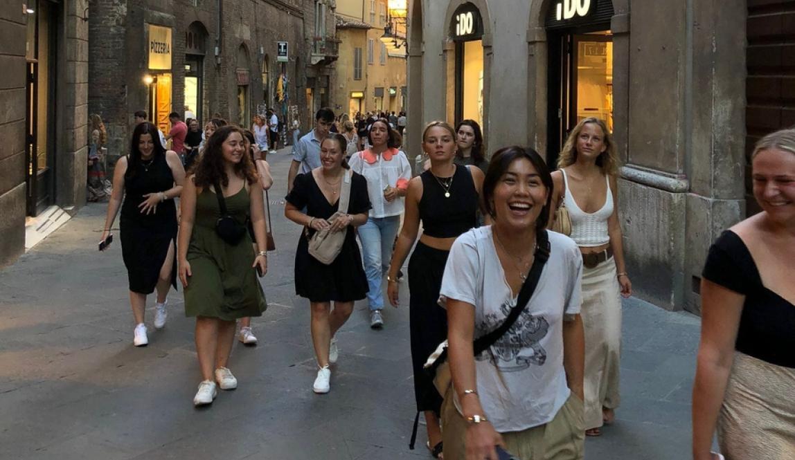 Students walking down the streets of downtown Siena during orientation