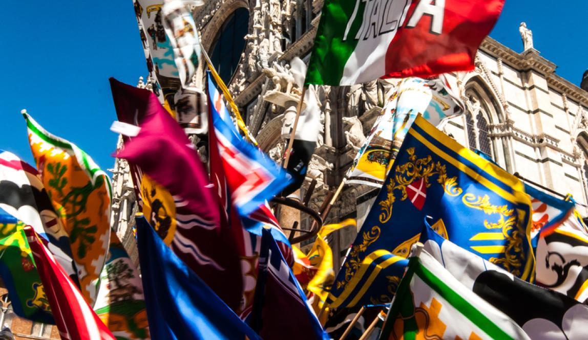 Flags for sale in front of the Duomo di Siena