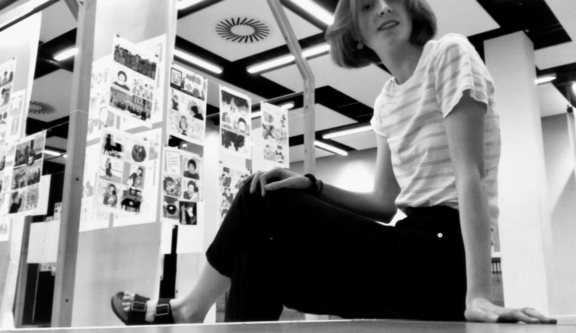 young woman in black and white against backdrop of lit house gallery 