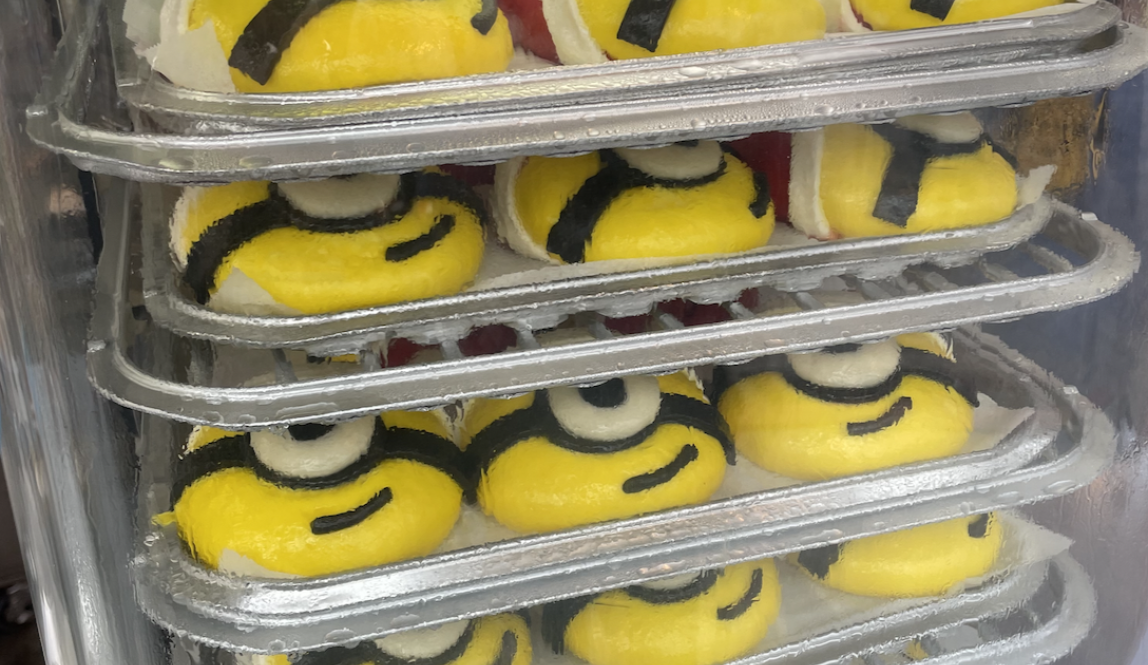 A photo of minion shaped buns with santa hats on