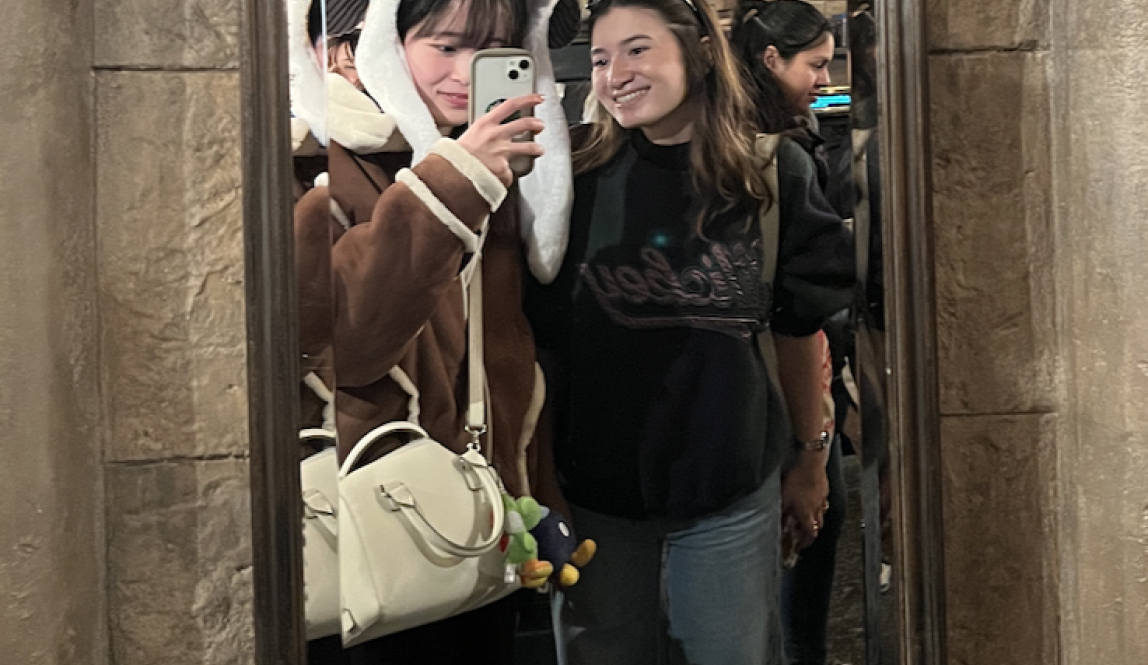 Mirror selfie with my friend who has a Snoopy hat on. Photo was taken in Hogsmeade!