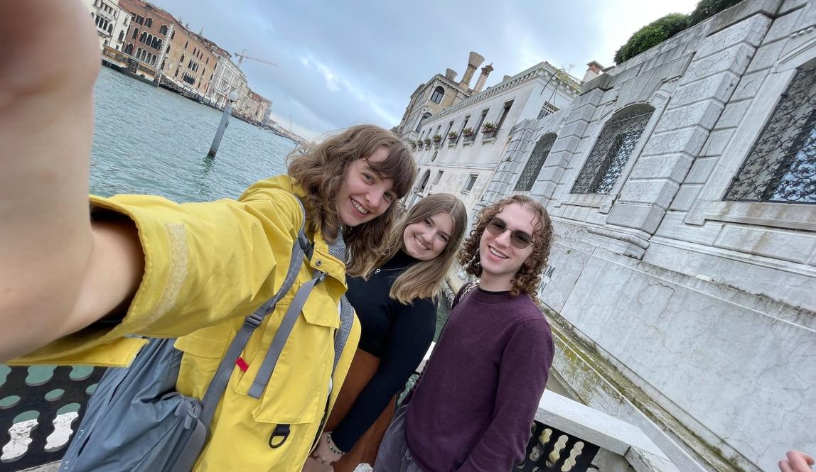 Selfie of three students in front of a canal in Venice. 