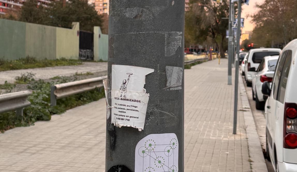 metal pole with two white stickers 