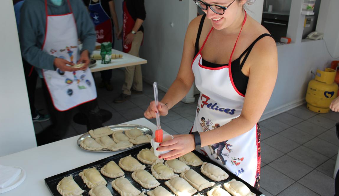 a student marinating empanadas in a cooking class