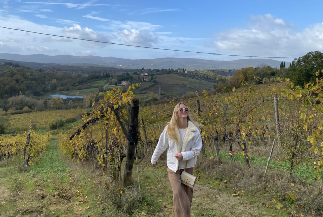 A student walks through a Tuscan landscape
