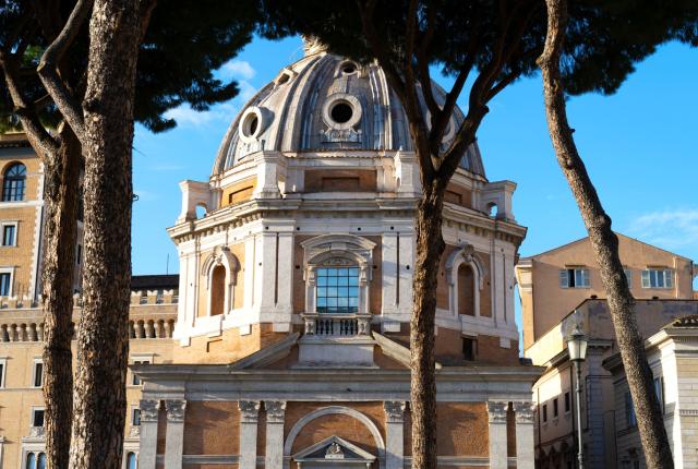A street view of the IES Abroad Rome Center, an ornate building with large windows and a domed roof.