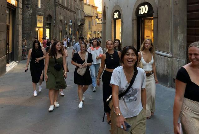 Students walking down the streets of downtown Siena during orientation
