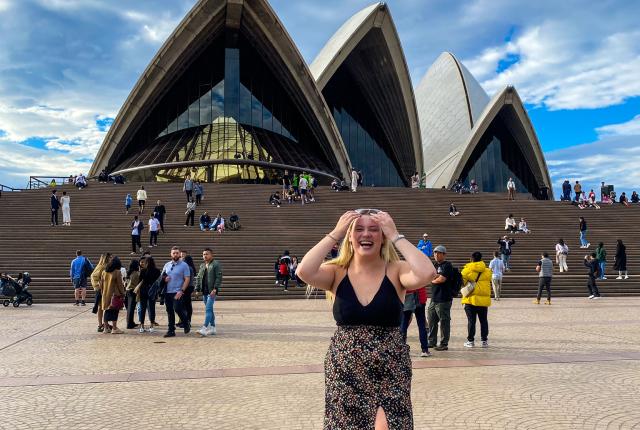 student standing in front of sydney opera house