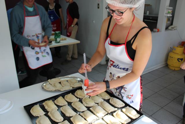 a student marinating empanadas in a cooking class