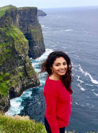 dublin student sits cliffside at the Cliffs of Moher