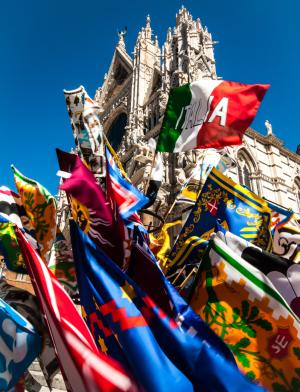 Flags for sale in front of the Duomo di Siena