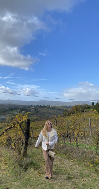 A student walks through a Tuscan landscape