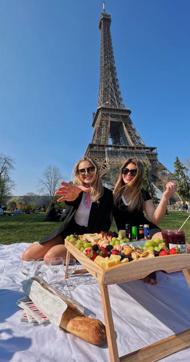 Two students having a picnic at the Eiffel Tower in Paris, France